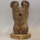 Wooden bear figure with kettlebells